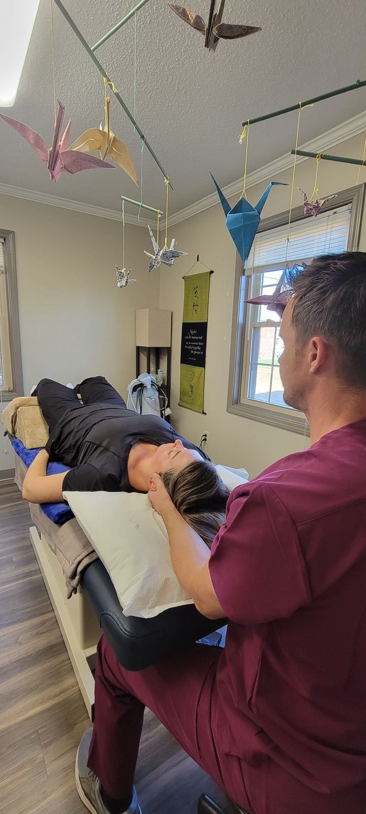 Dr. Starsiak performing cranial osteopathy